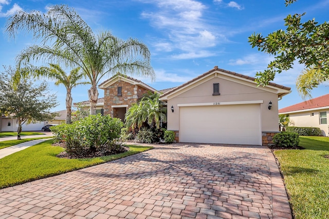 view of front of home with a garage and a front lawn