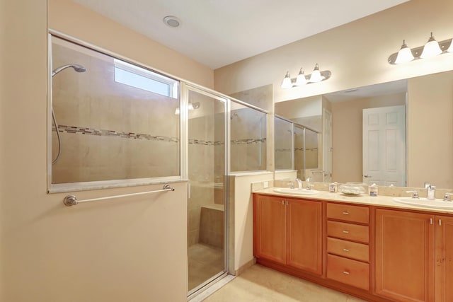 bathroom featuring tile patterned floors, vanity, and a shower with door