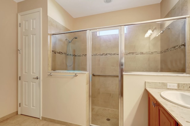 bathroom featuring vanity, tile patterned floors, and walk in shower