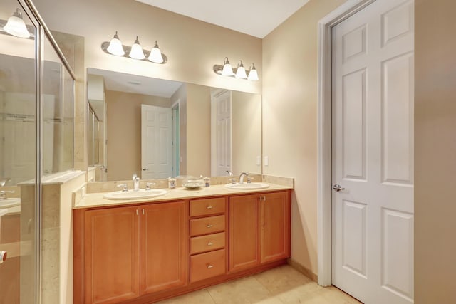 bathroom featuring tile patterned flooring, vanity, and a shower with door