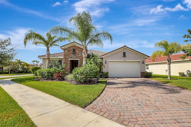 view of front facade with a garage and a front lawn