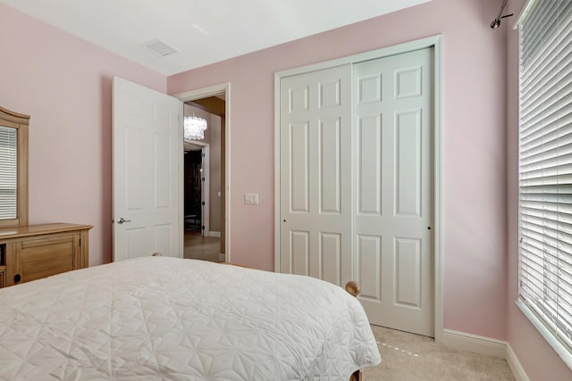 bedroom featuring light carpet and a closet