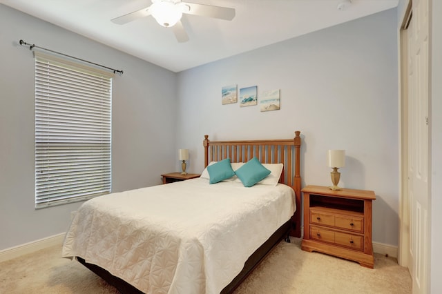 carpeted bedroom featuring a closet and ceiling fan