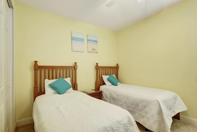 carpeted bedroom featuring a closet and ceiling fan