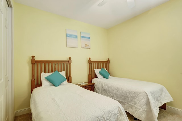 bedroom with ceiling fan, carpet floors, and a closet