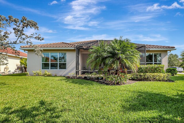 mediterranean / spanish-style house with a front yard and a garage