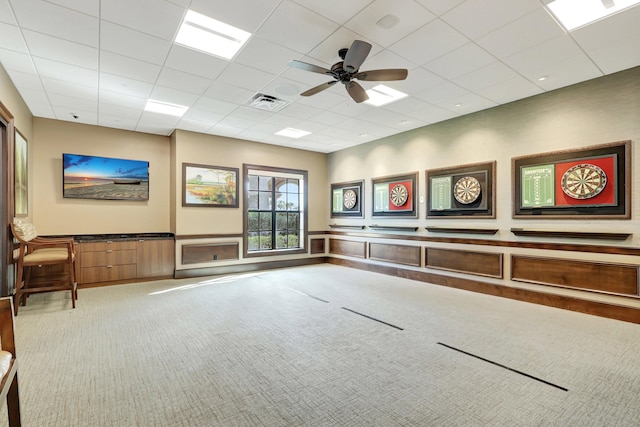 spare room with carpet flooring, a drop ceiling, and ceiling fan