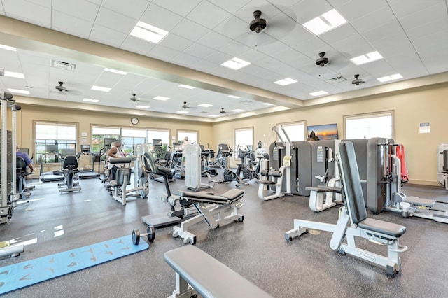 workout area featuring a paneled ceiling and ceiling fan