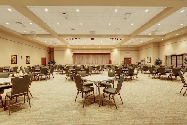 dining space with light carpet and a high ceiling