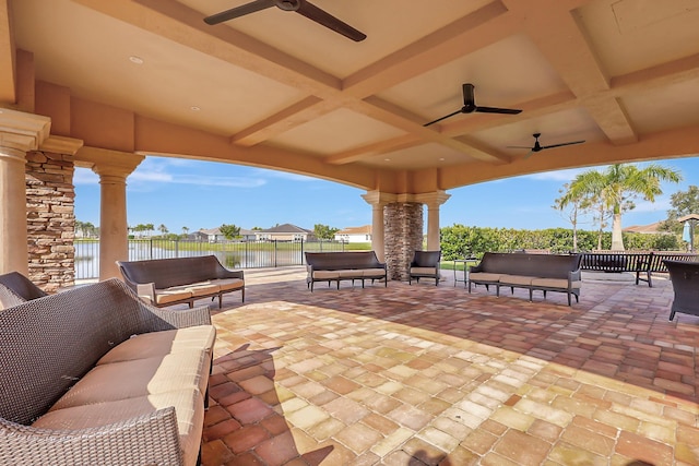 view of patio featuring a water view, ceiling fan, and outdoor lounge area