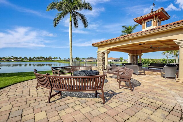 view of patio / terrace with outdoor lounge area, a water view, and ceiling fan