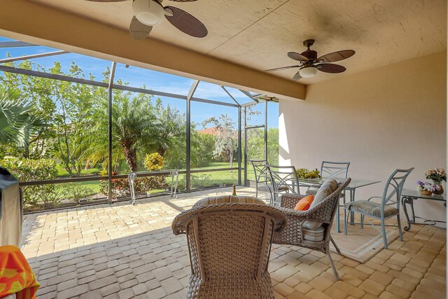 view of patio featuring a lanai, grilling area, and ceiling fan