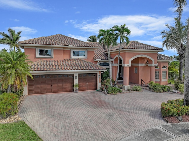 mediterranean / spanish house featuring a garage