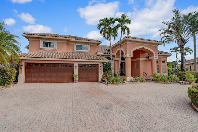 mediterranean / spanish house with a garage