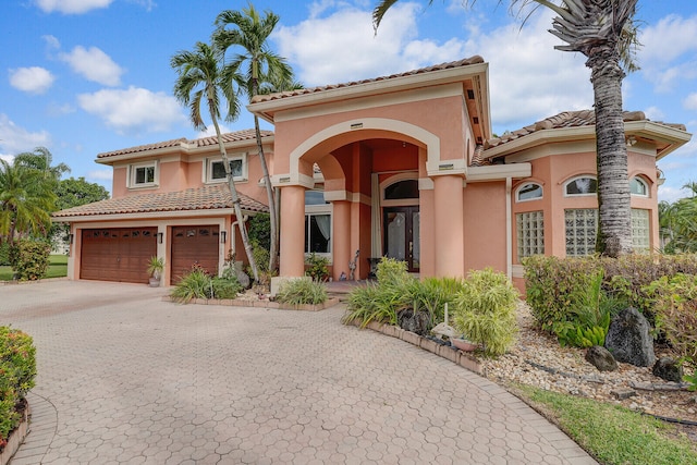 mediterranean / spanish house featuring a garage