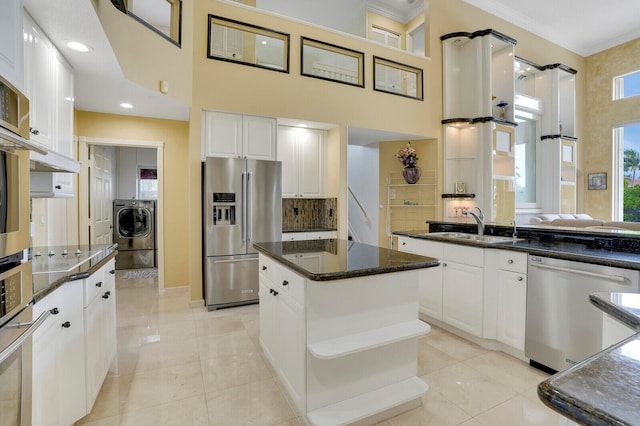 kitchen with a center island, light tile patterned floors, white cabinetry, and appliances with stainless steel finishes