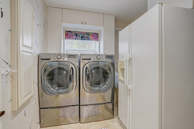 laundry room featuring light tile patterned floors and washer and dryer