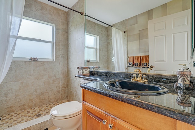 bathroom with a shower with shower curtain, tile patterned floors, vanity, and toilet