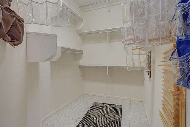 spacious closet with light tile patterned floors