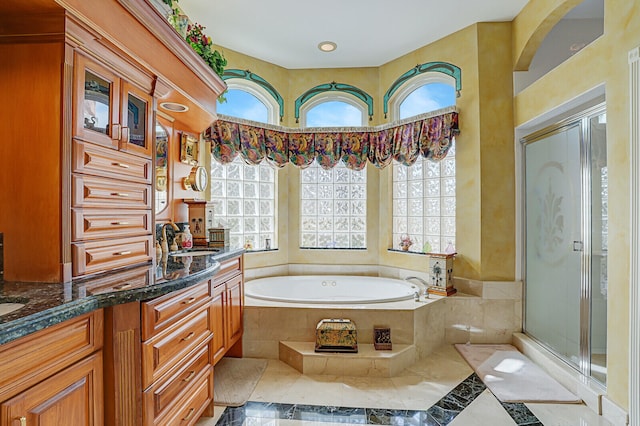 bathroom with shower with separate bathtub, vanity, and a healthy amount of sunlight