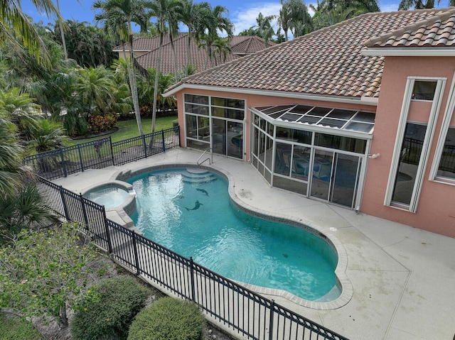 view of pool featuring a patio area and an in ground hot tub