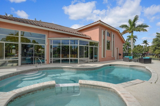 view of swimming pool with a patio area, an outdoor hangout area, and an in ground hot tub