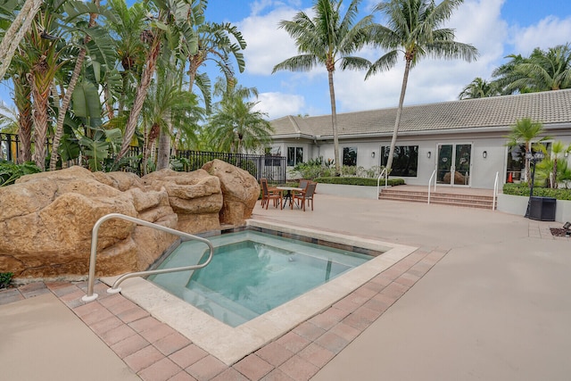 view of swimming pool with an in ground hot tub and a patio