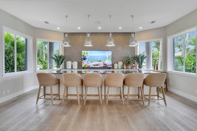 kitchen featuring pendant lighting, plenty of natural light, and a breakfast bar