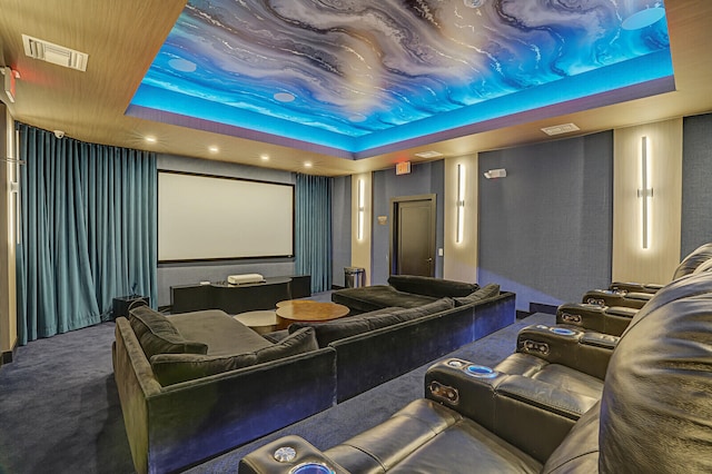 carpeted home theater featuring a tray ceiling