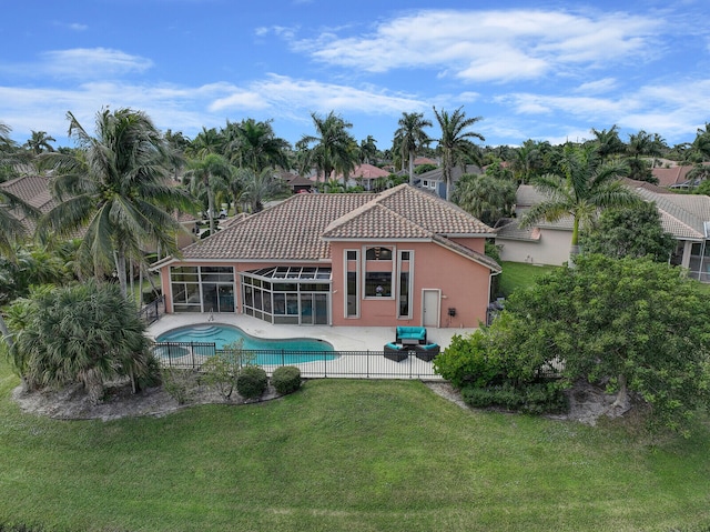 view of pool with a lawn, glass enclosure, and a patio area