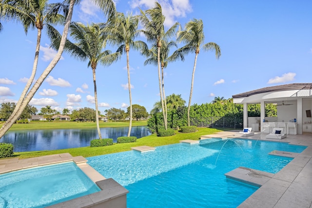 view of swimming pool featuring a yard, a water view, an outdoor bar, and ceiling fan