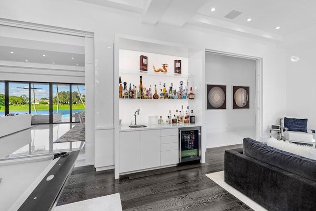 bar with white cabinets, sink, dark wood-type flooring, and beverage cooler