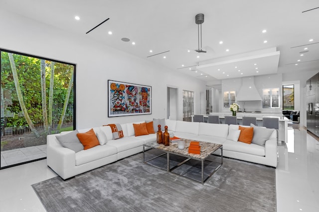 living room featuring tile patterned floors and ceiling fan