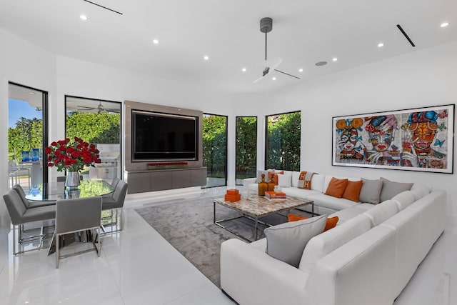 tiled living room with ceiling fan