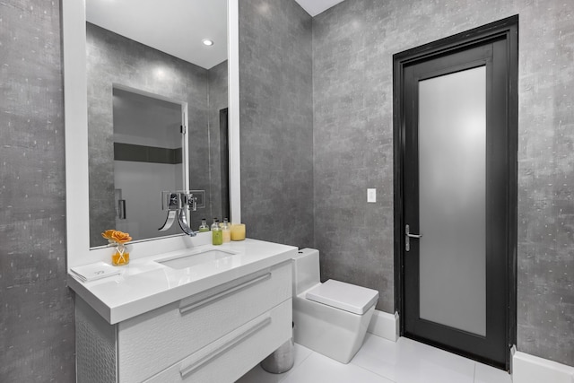 bathroom featuring tile patterned floors, vanity, and toilet