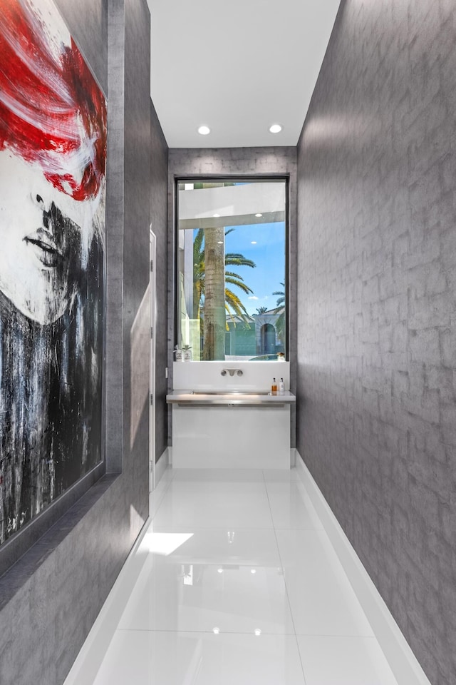 corridor featuring tile patterned flooring and tile walls