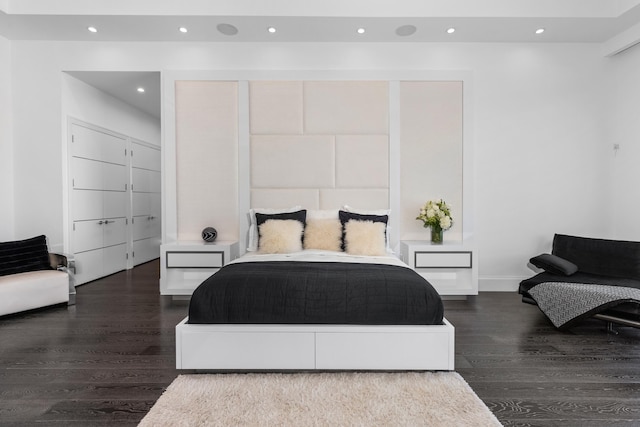 bedroom with dark hardwood / wood-style flooring