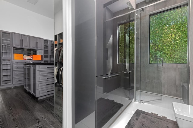 bathroom with hardwood / wood-style flooring and toilet