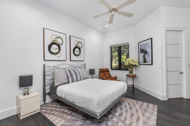 bedroom with ceiling fan and dark hardwood / wood-style flooring