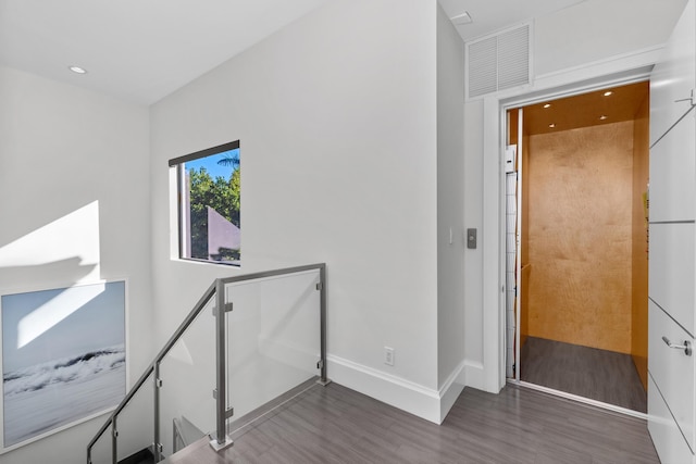 staircase featuring hardwood / wood-style floors