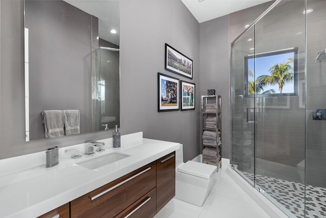 bathroom with tile patterned flooring, vanity, toilet, and a shower with shower door