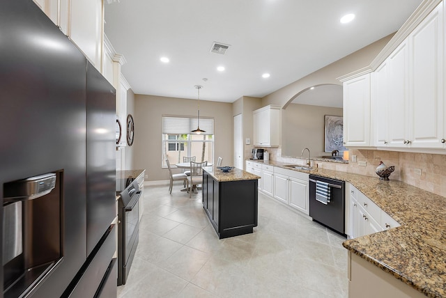 kitchen featuring pendant lighting, a center island, sink, tasteful backsplash, and stainless steel appliances