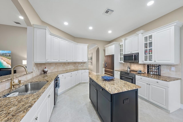 kitchen with white cabinetry, sink, a kitchen island, and stainless steel appliances