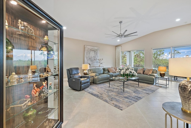 tiled living room with ceiling fan and lofted ceiling