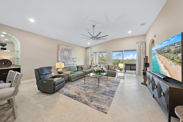 living room with ceiling fan, light tile patterned floors, and vaulted ceiling