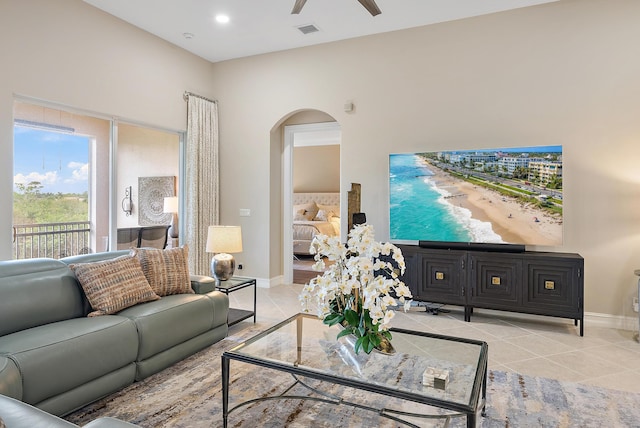 tiled living room with ceiling fan