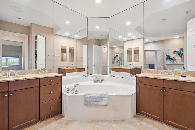 bathroom with tile patterned flooring, vanity, and independent shower and bath