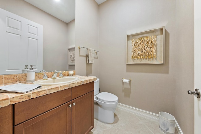 bathroom with tile patterned floors, vanity, and toilet