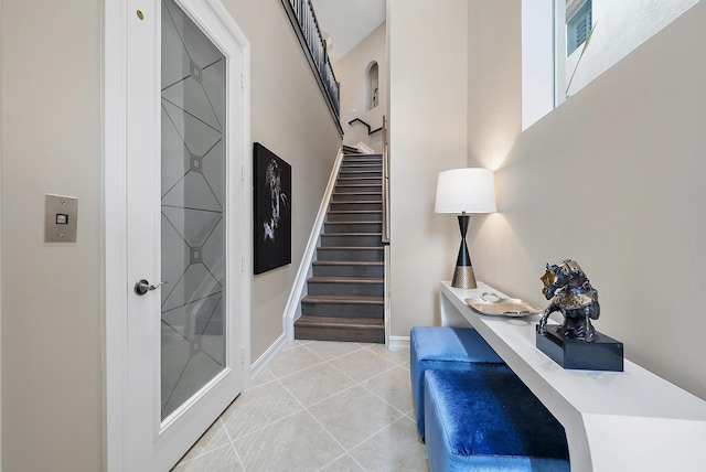 stairway featuring tile patterned flooring