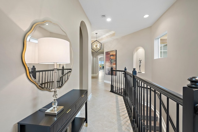 hallway featuring a notable chandelier